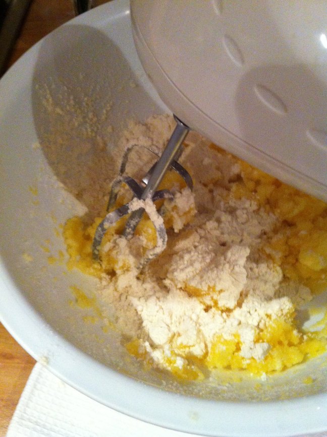 Beating butter, sugar, eggs, lemon zest, self-raising flour
